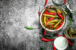 Pickled chili peppers in a bowl. photo