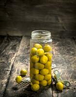 Pickled olives in glass jar. photo