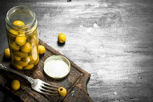 Pickled olives in jar. photo