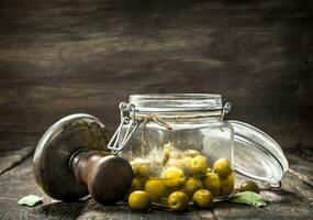Marinated olives with seamer. photo