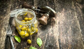 Marinated olives with seamer. photo