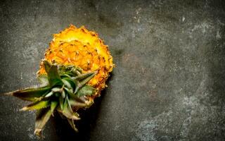 Sliced pineapple top view. On stone table. photo