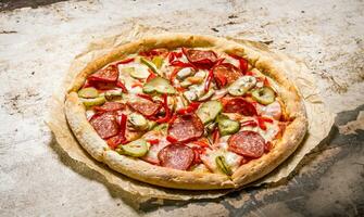 Baked pizza with meat and peppers . photo