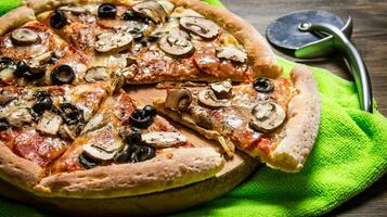 Delicious Italian pizza on the fabric. On wooden table. photo