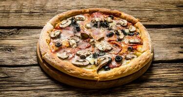 Italian pizza with olives and bacon . photo