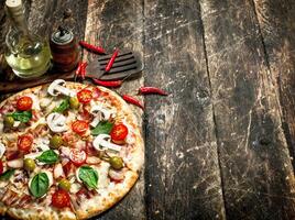 Fresh pizza. On wooden background photo