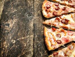 Pizza with spicy meat sausages and cheese. photo