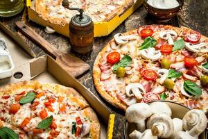 variety of pizzas with mushrooms and sauce. photo