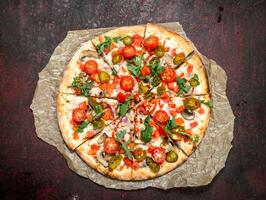 fresh pizza with tomatoes and greens. photo