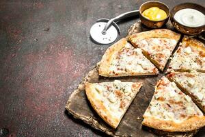 Cheese pizza. On rustic background. photo