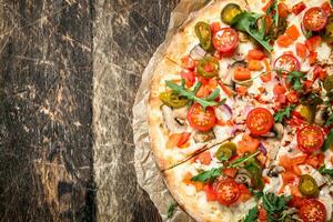 fresh pizza with tomatoes and greens. photo