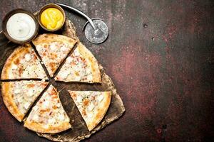 Cheese pizza. On rustic background. photo