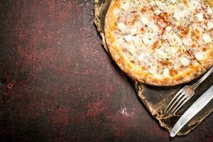 Cheese pizza. On rustic background. photo