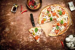 Fresh pizza with meat and tomatoes. photo