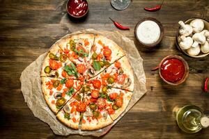 Hot Mexican pizza. On wooden table. photo