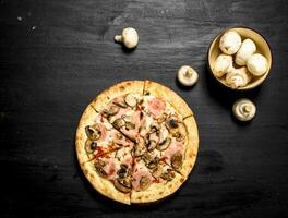 Pizza with ham, mushrooms and cheese. photo
