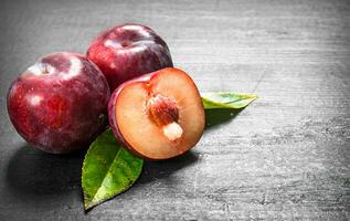 Fresh plums with leaves. photo