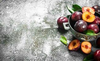 Ripe plums in a bowl. photo