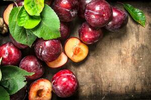 Ripe plums in a wooden tray. photo