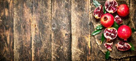 Ripe pomegranates on a cutting Board. photo