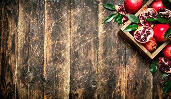 Fresh pomegranates in an old box. photo