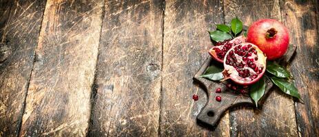 Ripe pomegranates on a cutting Board. photo