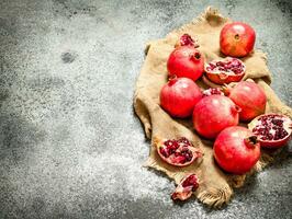 Fresh pomegranates on an old sack. photo