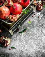 Ripe pomegranates on the scales. photo