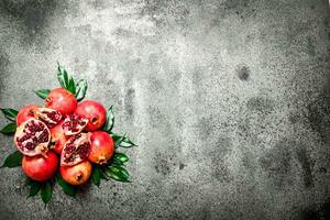 Fresh pomegranates with green leaves. photo