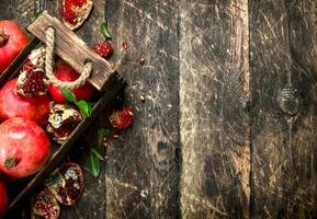 Fresh pomegranates in an old box. photo