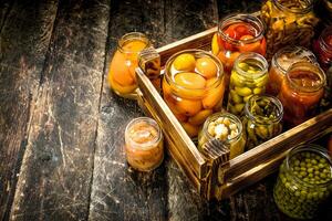Preserves mushrooms and vegetables in a box. photo
