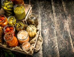 Preserves food with vegetables and mushrooms on an old tray. photo