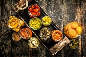 Preserves mushrooms and vegetables in a box. photo