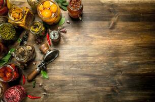 Marinated vegetables and mushrooms in glass jars with seamer. photo