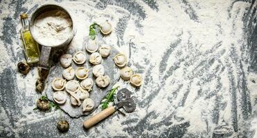 Fresh ravioli with flour and quail egg. photo