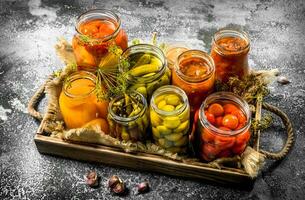 Preserved vegetables with mushrooms on an old tray. photo