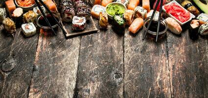 Japanese food. Sushi and rolls fresh seafood with soy sauce. On the old wooden background. photo