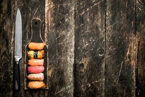 Japanese food. Fresh sushi from eel, shrimp and tuna on a wooden Board. On the old wooden background. photo