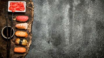 Japanese food. Seafood sushi with soy sauce. On rustic background. photo