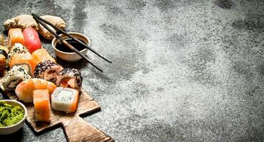 Japanese food. Fresh rolls with seafood and soy sauce. On rustic background. photo