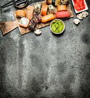 Japanese food. Fresh rolls with seafood and soy sauce. On rustic background. photo