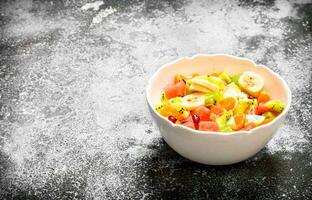 Tropical food . Fruit salad in a bowl. photo