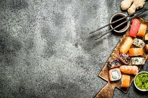 Japanese food. Fresh rolls with seafood and soy sauce. On rustic background. photo