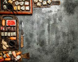 Traditional Japanese food. Sushi and rolls .On rustic background. photo