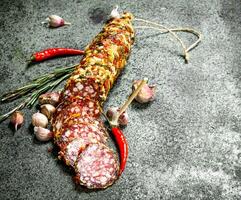 Salami with spices and herbs. photo