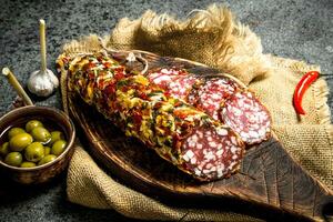 Salami of pork and beef with olives and spices. photo