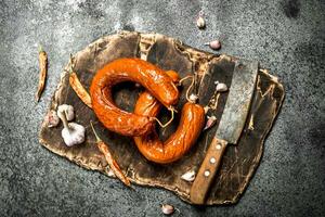 Krakow sausage with spices and garlic on the board. photo