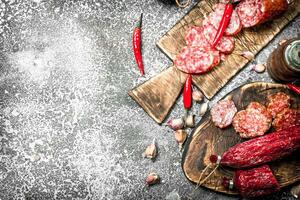 Salami background. Different kinds of salami with spices. photo