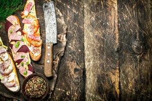 Sandwiches with meat, seafood and fresh vegetables on fresh bread. photo