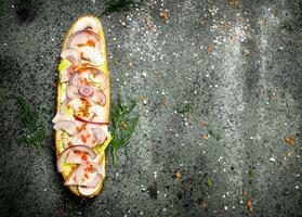 Sandwich with bacon, mushrooms and red onion on a fresh roll. photo